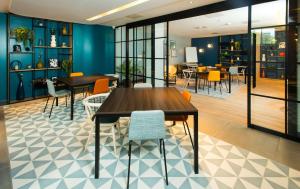 - une salle à manger avec une table et des chaises dans l'établissement Hampton by Hilton London Park Royal, à Londres