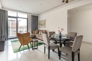 a living room with a table and chairs and a couch at Frank Porter - Damac Celestia in Dubai