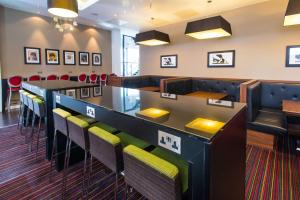 a bar in a restaurant with chairs and a table at Hampton By Hilton Liverpool City Centre in Liverpool