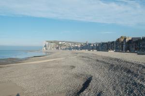 a view of a beach with buildings and the ocean at Au Jardin Saint Laurent in Eu +8 photos