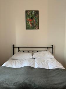 a bed in a bedroom with a picture on the wall at Śródmieście in Wałbrzych