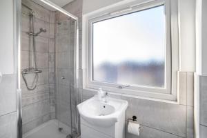 baño con lavabo, ducha y ventana en Leicester City Center The Boat House Building, en Leicester