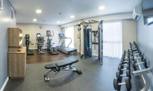 a gym with treadmills and machines in a room at Hilton Garden Inn Manchester Emirates Old Trafford in Manchester