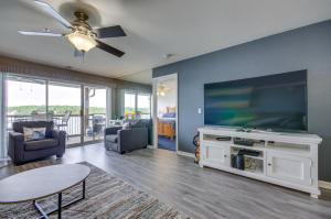 a living room with a large flat screen tv at Pool and Dock Access Osage Beach Retreat! in Osage Beach