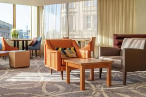 a hotel lobby with chairs and tables and windows at Hampton by Hilton Newcastle in Newcastle upon Tyne