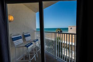 a balcony with two chairs and a view of the ocean at Emerald at Belleair Beach Club in Clearwater Beach
