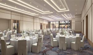 a banquet hall with white tables and chairs at InterContinental Hotels Bellevue at the Avenue, an IHG Hotel in Bellevue