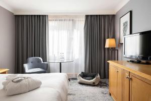 a hotel room with a bed and a flat screen tv at DoubleTree by Hilton Swindon Hotel in Swindon