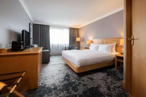 a hotel room with a bed and a television at DoubleTree by Hilton Swindon Hotel in Swindon