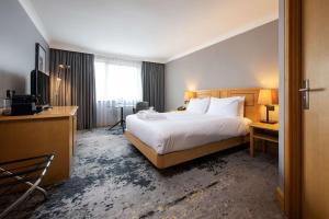 a hotel room with a large bed and a television at DoubleTree by Hilton Swindon Hotel in Swindon