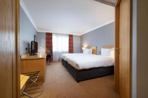 a hotel room with a bed and a desk at DoubleTree by Hilton Swindon Hotel in Swindon