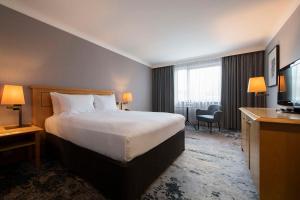 a hotel room with a bed and a television at DoubleTree by Hilton Swindon Hotel in Swindon