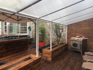 a pergola with an umbrella on a wooden deck at maison blanche in Eymet