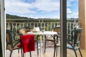 a table and chairs on a balcony with a view at Apartaments Condado by Marsol in Lloret de Mar