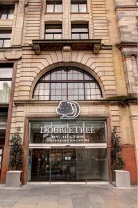 a building with a doughnut tree sign in front of it at Doubletree by Hilton Edinburgh City Centre in Edinburgh