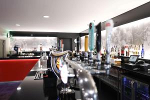 a bar with a long counter with bottles of alcohol at DoubleTree By Hilton Milton Keynes in Milton Keynes
