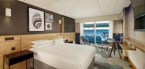 a hotel room with a bed and a table and chairs at DoubleTree by Hilton Coventry Building Society Arena in Coventry