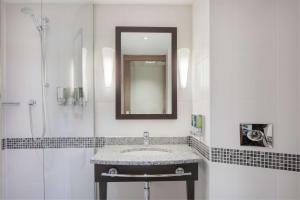 a bathroom with a sink and a mirror at Hampton by Hilton York in York