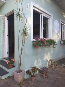 a house with a potted plant and a window at Pousada do Parque in Porto Alegre +26 photos