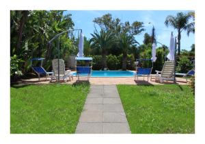 a group of chairs and a swimming pool at The Green Seaside in Fondachello +24 photos