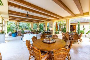 an outdoor patio with a wooden table and chairs at Sunny Vacation Villa No 71 in San Rafael del Yuma