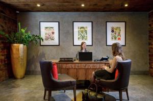 two women sitting at a desk with a laptop at Hilton London Bankside in London