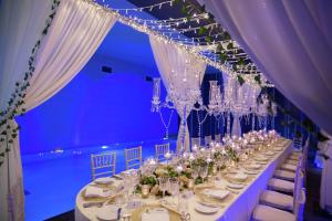 a long table with chairs and chandeliers in a room at Hilton London Bankside in London