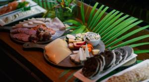 een tafel met kaas en vlees en andere voedingsmiddelen bij Hotel Hare Uta in Hanga Roa