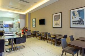 a dining room with tables and chairs in a restaurant at Hampton by Hilton London Croydon in Croydon