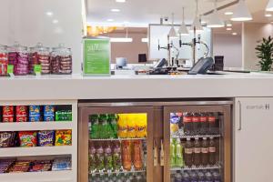 a store with a refrigerator filled with lots of drinks at Hampton by Hilton London Gatwick Airport in Horley