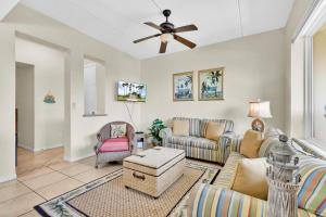 a living room with couches and a ceiling fan at Waterfront w boat slip - best of beach and bay! in South Padre Island