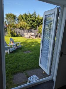 an open door to a yard with a patio at Hawarden near Chester in Hawarden