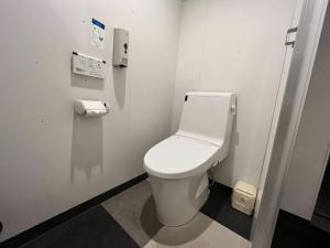 a bathroom with a white toilet in a stall at 煎 SEN in Matsue
