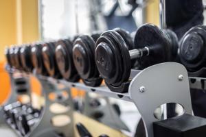 a row of dumbbells on a rack in a gym at The Trafalgar St. James, London Curio collection by Hilton in London