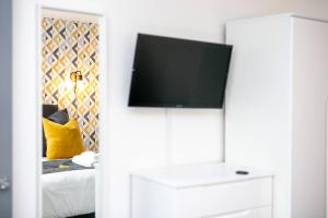 a room with a tv on top of a white cabinet at SCA - Luxurious Studio - VS5 in Wolverhampton