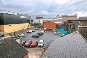 a parking lot with parked cars in a city at SCA - Luxurious Studio - VS5 in Wolverhampton