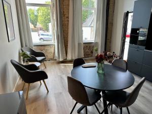 a dining room with a table and chairs and a window at Torvet17 Nr1 - 42m2 in Maribo