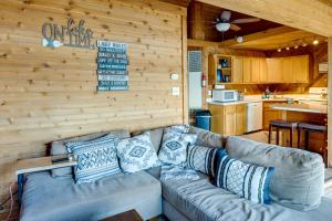 a living room with a couch and a kitchen at Okauchee Lake Vacation Rental with Boat Dock! in Oconomowoc