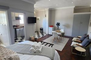 a bedroom with a bed and a living room at Ebenezer in Somerset West