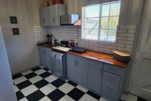 a small kitchen with a counter and a sink at Ebenezer in Somerset West