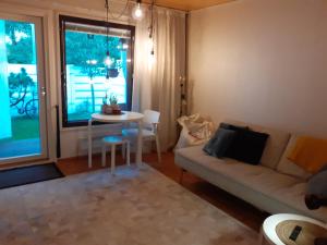 a living room with a couch and a table at Ann's terraced house with sauna in Vantaa