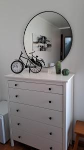 a dresser with a mirror on top of it at APT Nazaré in Nazaré