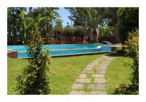a swimming pool in the yard of a house at The Green Seaside in Fondachello