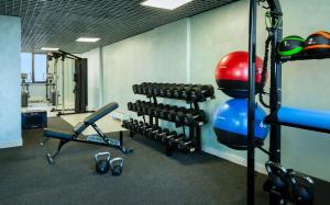 a gym with a bunch of dumbbells and weights at Hampton By Hilton Turkistan in Türkistan