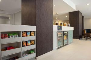 a food pantry with a refrigerator in a room at Hampton by Hilton Cluj-Napoca in Cluj-Napoca