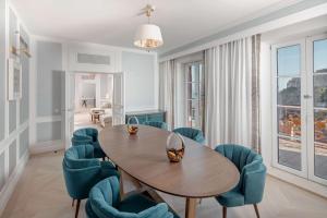 a dining room with a table and blue chairs at Hilton Imperial Dubrovnik in Dubrovnik