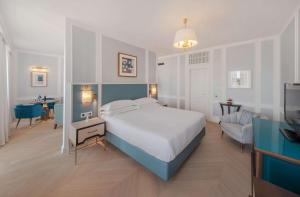 a bedroom with a large bed and a living room at Hilton Imperial Dubrovnik in Dubrovnik