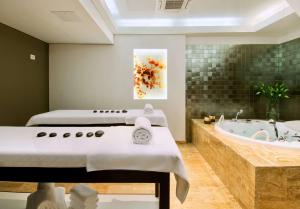 a bathroom with two beds and a bath tub at Hilton Imperial Dubrovnik in Dubrovnik