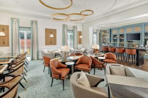 a restaurant with tables and chairs and a bar at Hilton Imperial Dubrovnik in Dubrovnik