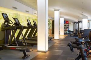 a gym with treadmills and exercise bikes in a room at Hilton Frankfurt Airport in Frankfurt/Main